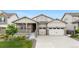 Charming home with a covered porch, two-car garage, and well-maintained lawn and landscaping at 8814 S Winnipeg Ct, Aurora, CO 80016