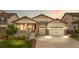Inviting home exterior with a charming front porch, two-car garage, and manicured landscaping at 8814 S Winnipeg Ct, Aurora, CO 80016