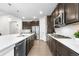 Beautiful kitchen featuring stainless steel appliances, dark cabinets, and a large center island with white countertop at 8814 S Winnipeg Ct, Aurora, CO 80016