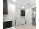 Laundry room with modern appliances, overhead cabinets, and convenient sink at 8814 S Winnipeg Ct, Aurora, CO 80016