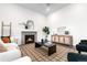 Inviting living room with a cozy fireplace, stylish furniture, and ample natural light at 8814 S Winnipeg Ct, Aurora, CO 80016