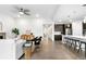Open concept living area with hardwood flooring, sleek furniture, and a view of the modern kitchen at 8814 S Winnipeg Ct, Aurora, CO 80016