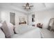 Well-lit main bedroom with an open layout, showing access to the bathroom and a sitting area at 8814 S Winnipeg Ct, Aurora, CO 80016