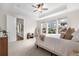 Main bedroom with large windows, a ceiling fan, and neutral decor at 8814 S Winnipeg Ct, Aurora, CO 80016