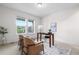 Bright office with neutral palette, two large windows, and a decorative rug at 8814 S Winnipeg Ct, Aurora, CO 80016