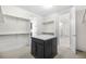 Walk-in closet with custom shelving, center island, and plush carpet at 8814 S Winnipeg Ct, Aurora, CO 80016