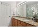 Bathroom with double sinks, granite countertops, and a walk-in shower at 18726 E Yale Cir # F, Aurora, CO 80013