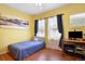 Cozy bedroom with a yellow wall and hardwood floors at 18726 E Yale Cir # F, Aurora, CO 80013