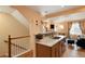 Open kitchen with a breakfast bar overlooking the living room at 18726 E Yale Cir # F, Aurora, CO 80013