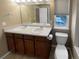 Bathroom features a double vanity with a large mirror, and a toilet at 24963 E Hoover Pl, Aurora, CO 80016