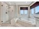 Bright bathroom features a separate shower and soaking tub with tile surround and window view at 1820 S State 83 Hwy, Franktown, CO 80116