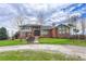 Spacious brick home featuring a well-manicured lawn and ample natural light, with mature trees lining the property at 1820 S State 83 Hwy, Franktown, CO 80116