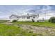 Quaint one-story home with white siding, a detached garage, and a large, grassy yard at 1820 S State 83 Hwy, Franktown, CO 80116