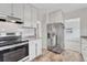 Bright kitchen with stainless steel appliances, white cabinets, and modern countertops at 1820 S State 83 Hwy, Franktown, CO 80116
