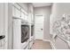 Functional laundry room with modern washer and dryer units, storage cabinets, and tile flooring at 1820 S State 83 Hwy, Franktown, CO 80116