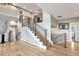 Open staircase features modern railings and abundant natural light from surrounding windows at 1820 S State 83 Hwy, Franktown, CO 80116