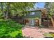 Inviting backyard with mature landscaping, a pergola-covered patio, and lush greenery for outdoor enjoyment at 9113 E Evans Way, Denver, CO 80231