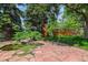 Scenic backyard with a decorative pond, stone pavers, mature trees and charming garden accents at 9113 E Evans Way, Denver, CO 80231