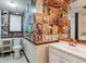 Bathroom adorned with unique vintage magazine decor, a toilet, and a vanity sink at 9113 E Evans Way, Denver, CO 80231