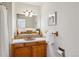 Charming bathroom featuring a wood vanity, decorative tile, and a classic, neutral color palette at 9113 E Evans Way, Denver, CO 80231