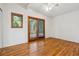 Bedroom featuring hardwood floors and access to a private deck via a sliding door at 9113 E Evans Way, Denver, CO 80231