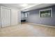 Bedroom with blue walls, neutral carpeting, built-in desk and closet at 9113 E Evans Way, Denver, CO 80231