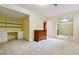 Bedroom with sunny yellow walls, a closet, shelves and desk at 9113 E Evans Way, Denver, CO 80231
