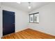 Bedroom featuring hardwood floors, a ceiling light, and a small window at 9113 E Evans Way, Denver, CO 80231