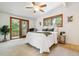 Bright bedroom with a sliding door to the deck and comfortable furnishings at 9113 E Evans Way, Denver, CO 80231