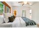 Bedroom featuring vaulted ceilings, a ceiling fan, and large windows at 9113 E Evans Way, Denver, CO 80231