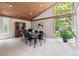 Dining room featuring a wood paneled ceiling and large windows at 9113 E Evans Way, Denver, CO 80231