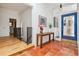 Bright foyer with terracotta floors and blue door at 9113 E Evans Way, Denver, CO 80231