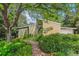Charming brick home featuring a lush garden and a welcoming brick walkway at 9113 E Evans Way, Denver, CO 80231