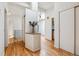 Hallway featuring hardwood floors, white walls, and lots of natural light at 9113 E Evans Way, Denver, CO 80231