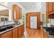 Bright kitchen featuring granite countertops, wood cabinets and vaulted ceilings at 9113 E Evans Way, Denver, CO 80231
