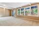 Open living room with sliding glass doors that provide access to the rear deck at 9113 E Evans Way, Denver, CO 80231