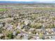 An aerial view shows a residential area with mature trees and a distant view of snow-capped mountains at 13071 Emerson St, Thornton, CO 80241