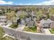 Aerial view of a home in a suburban neighborhood with mature trees and well-manicured lawns, and mountain views at 13071 Emerson St, Thornton, CO 80241