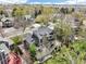 An aerial view of a home showcasing its multi-level decks, mature landscaping, and surrounding suburban neighborhood at 13071 Emerson St, Thornton, CO 80241