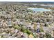 Aerial view of a residential neighborhood with mature trees surrounding a large lake and park at 13071 Emerson St, Thornton, CO 80241