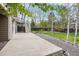 A spacious concrete back patio features stone accents, mature trees and steps leading up to a deck at 13071 Emerson St, Thornton, CO 80241