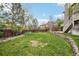 The backyard features a large grassy area with a wooden fence and mature landscaping at 13071 Emerson St, Thornton, CO 80241