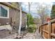 Home exterior showing backyard with stone steps, fence and trees at 13071 Emerson St, Thornton, CO 80241