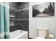 Modern bathroom featuring a tub with tiled walls, a showerhead, and contemporary fixtures at 13071 Emerson St, Thornton, CO 80241