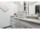 A stylish bathroom featuring dual sinks, granite countertops, and custom cabinetry for storage at 13071 Emerson St, Thornton, CO 80241