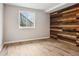 Bedroom featuring hardwood floors and a wall accent with designer wood panels at 13071 Emerson St, Thornton, CO 80241