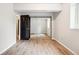 Bedroom featuring hardwood floors, mirrored closet, and neutral paint at 13071 Emerson St, Thornton, CO 80241