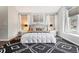 Cozy main bedroom with an accent rug, neutral decor, and natural light at 13071 Emerson St, Thornton, CO 80241