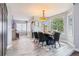 Charming dining area featuring a modern table setting, ample natural light, and a view into the kitchen at 13071 Emerson St, Thornton, CO 80241