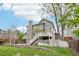 The home features an exterior elevation view from the back yard with a two-tiered deck and mature trees at 13071 Emerson St, Thornton, CO 80241